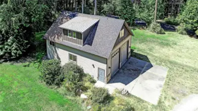 RV garage will accommodate 4 vehicles. 12.5 foot overhead doors to shelter all your wheeled toys. Additional RV parking pad and electric charging station. Roughed in 1 bedroom/1 bath Detached additional dwelling unit on upper level.
