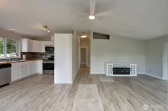 Welcome home. Completely updated kitchen with new flooring, cabinets, fixtures, appliances and lighting to the left, hallway the the bedroom's, bathrooms and utility room. Living room to your right.