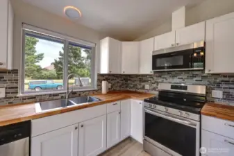 Completely updated kitchen with new flooring, cabinets, fixtures, appliances and lighting.