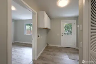Plenty of room in this laundry located centrally to the bedrooms, bathroom and back door with handicap ramp. The doorway goes to bedroom #2.