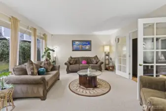 Elegant French doors connect the living and dining room/office, adding a timeless touch to the space.