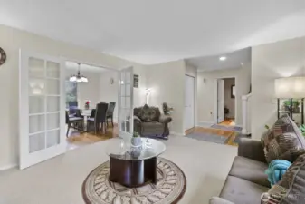 Elegant French doors connect the living and dining room/office, adding a timeless touch to the space.