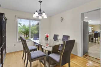 The formal dining room flows seamlessly into the kitchen, making entertaining and everyday meals both convenient and welcoming.
