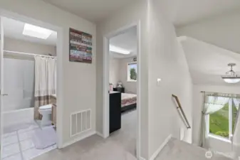 Upstairs offers four bedrooms, including the master suite and a full bathroom, with skylights in the shared bathroom and hallway that flood the space with natural light.