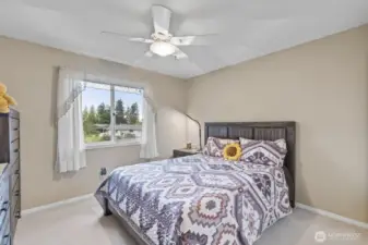 Bedroom two offers generous space and peaceful views of the backyard gardens.