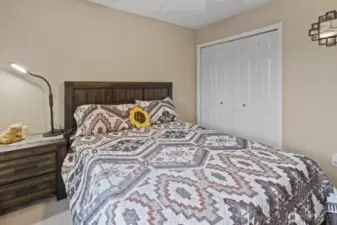 This bedroom also features a spacious built-in double closet, providing ample storage while maintaining an open, airy feel.