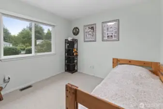 Bedroom four offers front yard views and a built-in single closet, making it move-in ready and perfectly functional.