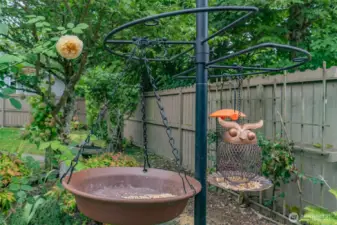 Enjoy a backyard alive with blooming flowers and the cheerful sounds of birds singing—a peaceful, nature-filled retreat.