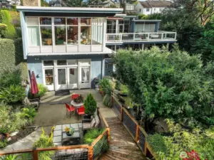 South Elevation  Three distinct levels step down the bluff, with extensive glazing and decks opening toward the gardens.