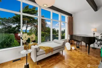 Main Living Room  Floor-to-ceiling windows and exposed beams define the primary gathering space, oriented to light and landscape.