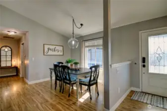 Entrance, dining room and hall to primary bedroom and laundry room/garage.