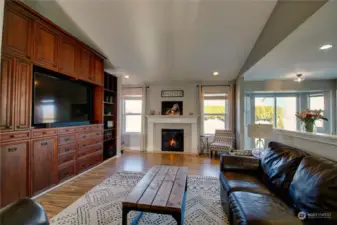 Great room with a wall of built-in cabinets and gas fireplace.