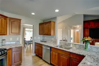 Large kitchen with loads of cabinets, granite countertops and newer appliances.