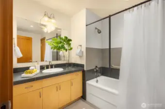 The primary bathroom’s finishes continue the them of the rest of the home – timeless, understated, and refined. The tub/shower offers an unobtrusive pull-up bar for those who may appreciate this handy feature.