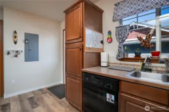 Large cabinets on this end of Kitchen provide extra storage. Door leading to backyard and detached garage visible.