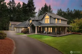 Beautiful 2.14-acre Fox Island estate with a welcoming wraparound porch, fresh exterior paint, manicured gardens, and a circular driveway. Lush landscaping and mature trees create privacy and charm from the moment you arrive.