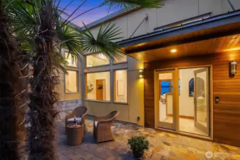 The property starts along Maplewild (see the aerial picture highlighting the approximate boundaries of the parcel), flows into the substantial parking area (rare feature on the water locally) and to the fenced courtyard and main home entrance.