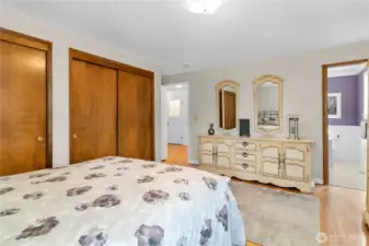 Spacious main floor primary bedroom with en suite and double closets