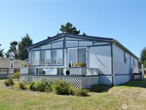 Rear view of the home w/ rear deck.
