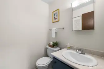 Main floor half bath with a large storage closet.