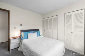 Primary bedroom with dual closets connected through the center.