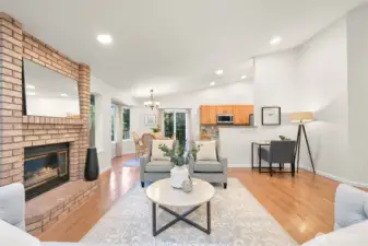 The open living room centers around the cozy fireplace.