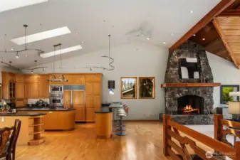 Notice how high the ceilings are. View the kitchen and partial of the living space, the breakfast bar from the hallway looking out.