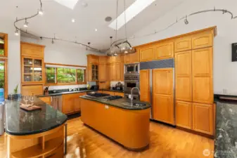 This kitchen is larger than this photo appears. There's so much storage for all seasons of the year with more underneath on both sides of this photo and in the island. Open cooking concept and skylights directly above you.