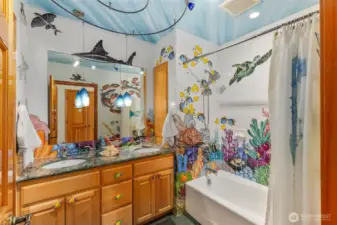 Under the Sea. This nautical inspired bathroom is one of a kind. The original owners hired a professional painter to hand paint part of this nice-sized bathroom.
