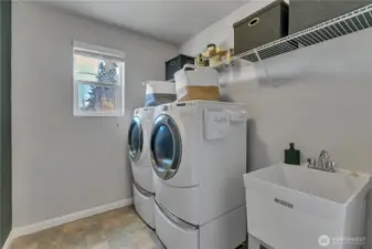 Convenient laundry room upstairs with utility sink. Washer & dryer stay with home