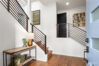 This spacious entry features an open stairwell that soars three floors as well as 2 closets. The interior garage door is straight ahead in the center.