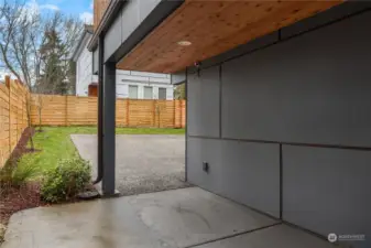 Just off the garage is this partially covered patio and breezeway. A man door is off to the right for easy access to the garage from the side without opening the main garage door.