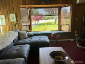 Living room with auto blind part way down