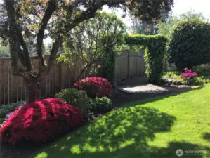 The yard boasts colorful, mature landscaping