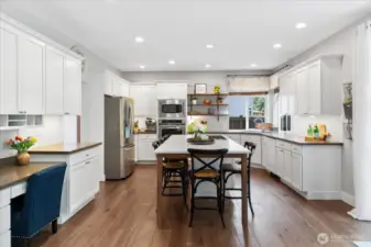 Here's a show-stopper kitchen for ya! XL quartz island with seating for 5! Home Command Center on the left for the organizing and ordering that needs to be done in a home of this size. Big and Beautiful best describe this kitchen.