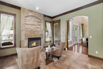 Sitting area with gas fireplace right off the kitchen eating area. Windows letting in the light and extending you into the magnifcent yard.  You can just picture yourself enjoying your drink of choice.