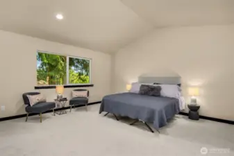 Spacious primary suite with vaulted ceilings.