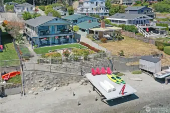 Main Beach House, waterside dock, sandy beach, and Guest Cottage behind the Main House