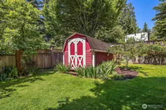 The expansive yard has fruit trees and a shed for storage