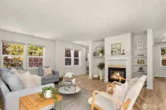 Spacious living room with gas fireplace. Surround yourself in windows!