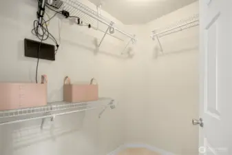 Primary Suite walk-in closet. (Also contains the security system)