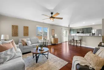 Living room opens to kitchen and looks out to backyard