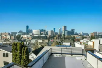 A spectacular rooftop deck captures sweeping panoramic views of the Seattle skyline