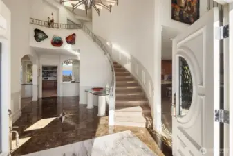 Note the inviting entry with high end finishes, details and marble floor with a deign highlight.