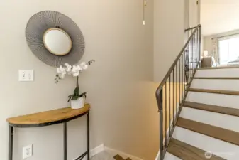 As you enter through the front door the stairs lead up to the living room, dining room full length deck, kitchen and half bathroom.