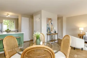 Across from the kitchen  is the pantry door and behind the hall if the half bathroom.