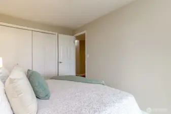 Double sided closet and leads out to the hallway, full bathroom, primary bedroom and full bathroom.