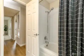 Full bathroom with new flooring, vanity, sink and paint.