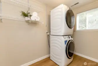 Large, spacious utility room with  stackable Washer and Dryer that stay. Plenty of room for extra storage here.