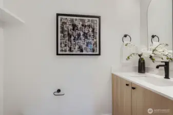 Convenient powder adjacent to mud/room & garage.